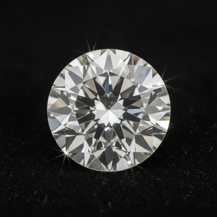 Brilliant-cut diamond gemstone resting on black velvet